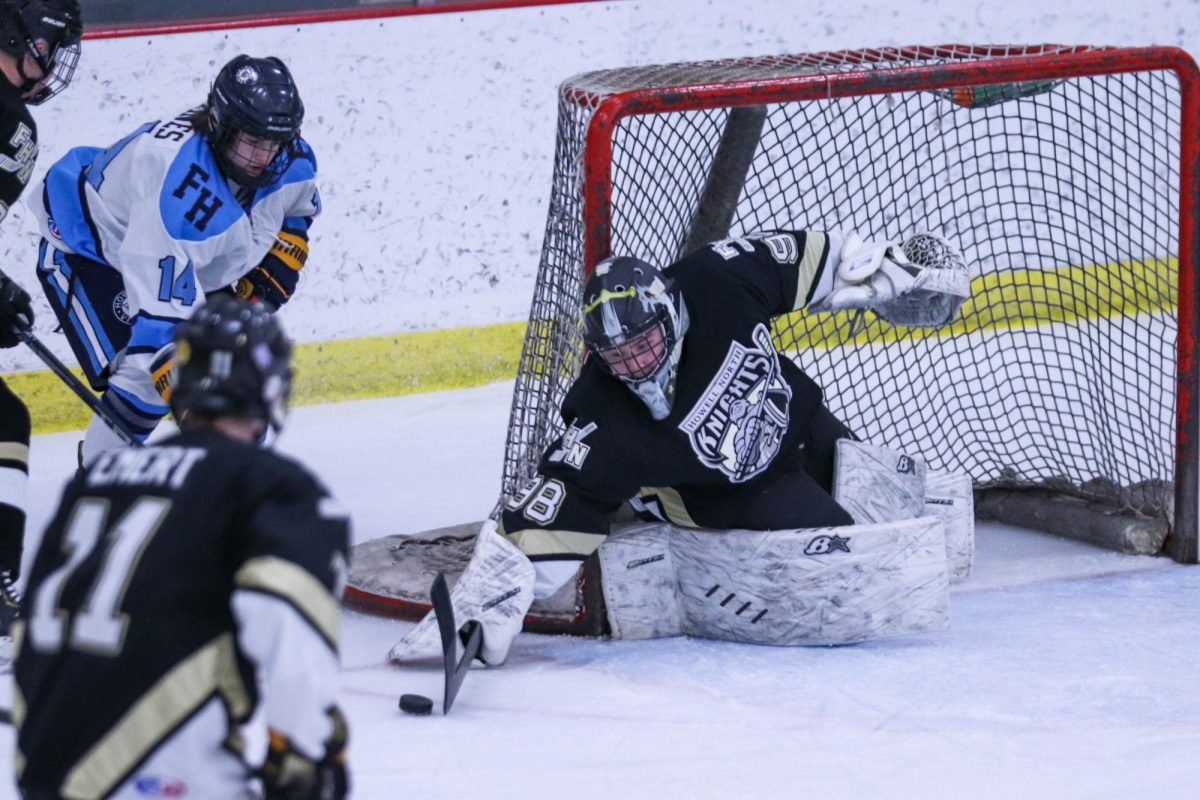 The FHN Goalie attempts to make a save against Francis Howell. 
