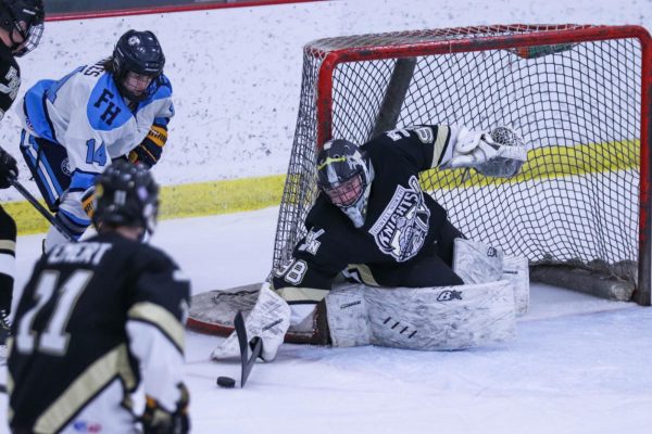 The FHN Goalie attempts to make a save against Francis Howell. 