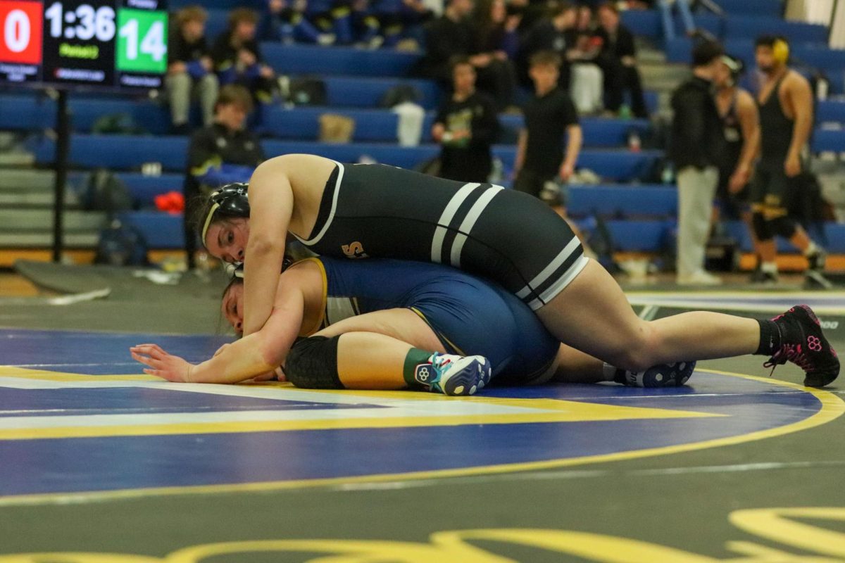 Senior Maddie Howell gets on top of her opponent, getting the advantage during her match at Howell on Jan. 28.