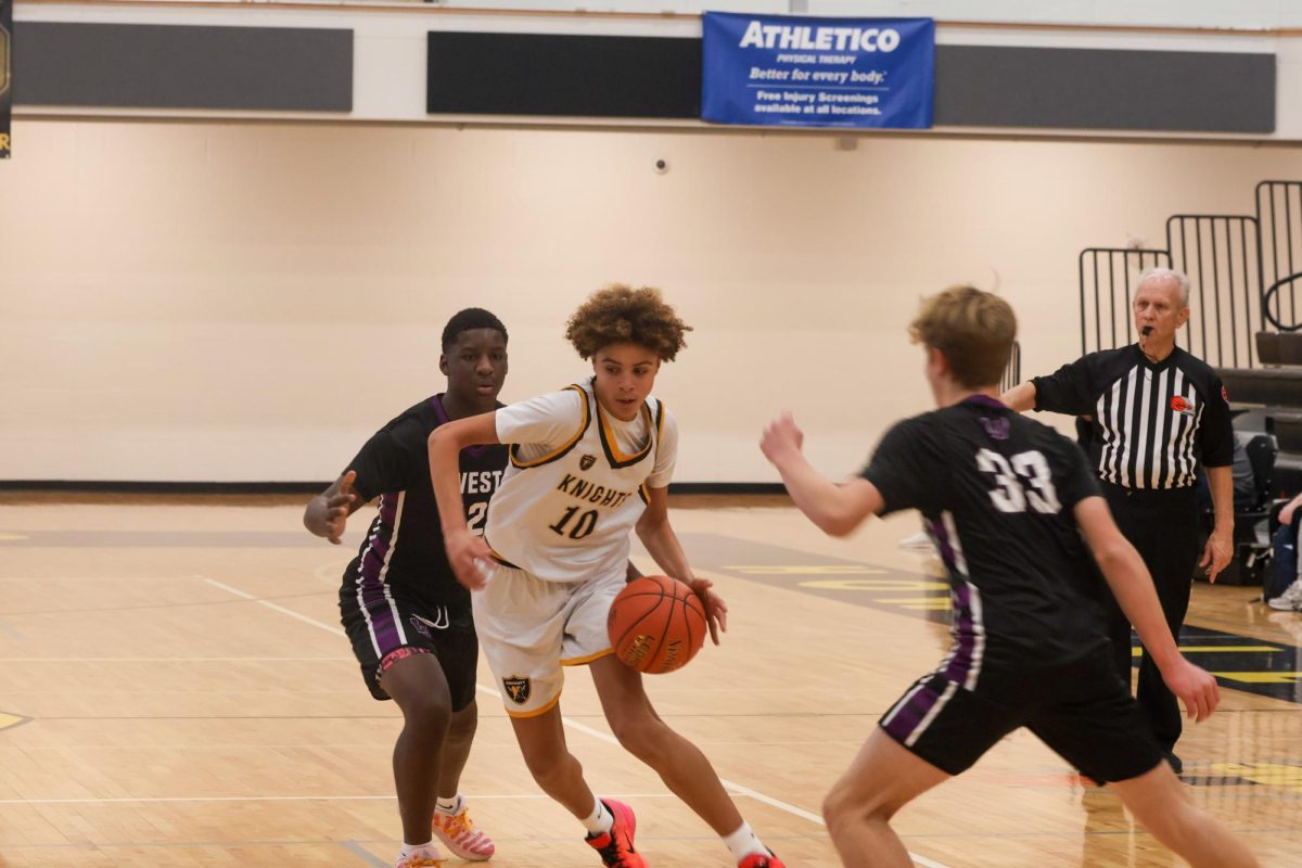 Freshman William Tomlin dribbles the ball at the Howell North C-Team basketball game against Fort Zumwalt West on Wednesday, Jan. 28. William dribbled into the paint and attempted to force a layup. 
