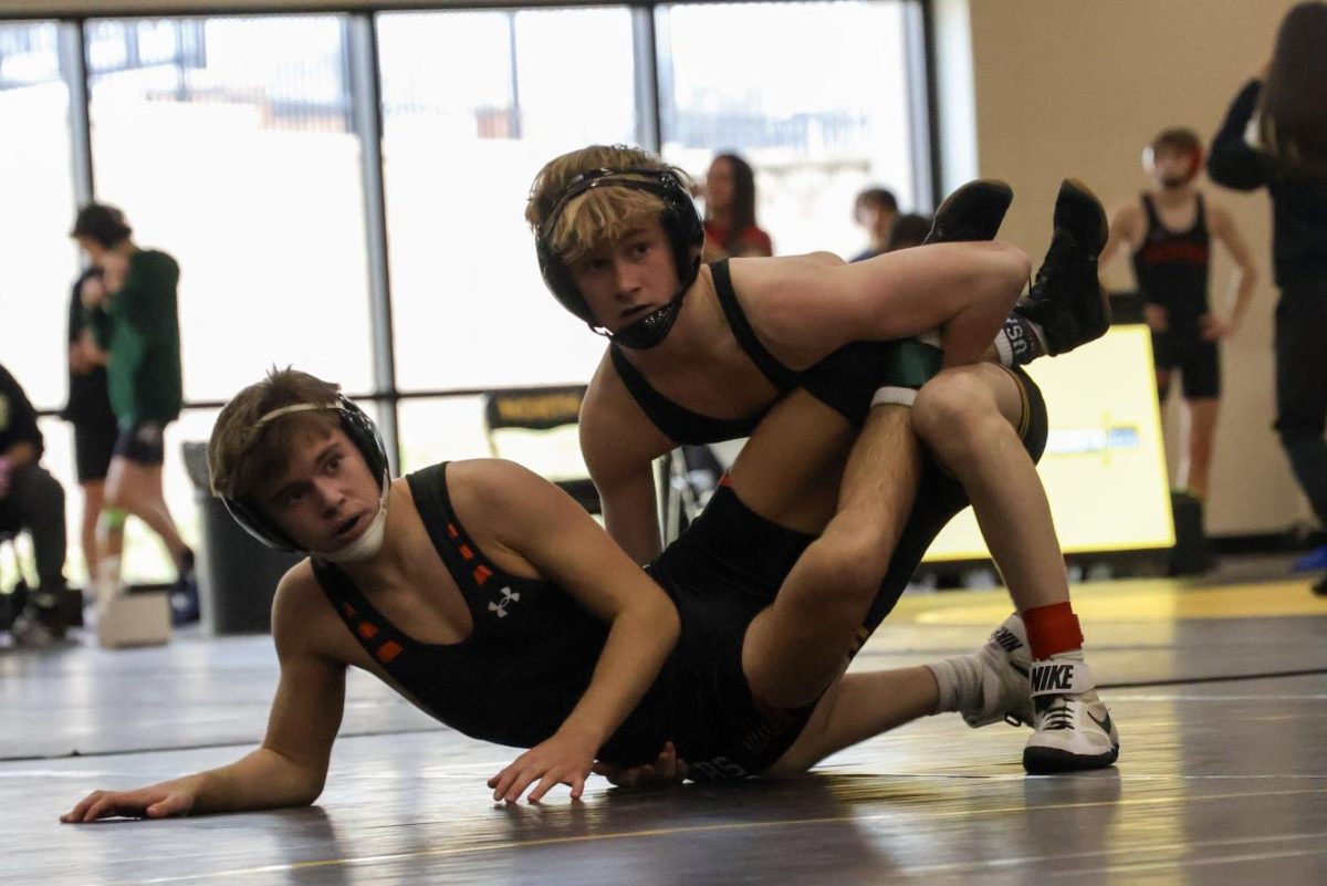 Junior Wyatt Danneger holds opponent at a tournament, walking out as top finisher