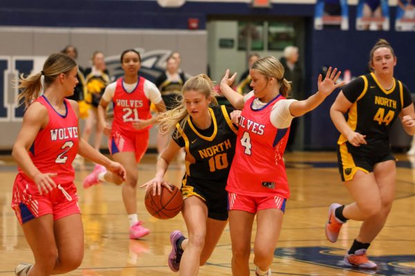 Senior Addy Jones dribbles towards the opposing teams basket, while being heavily guarded. The Timberland Wolves hosted the Lady Knights on Tuesday, Feb. 24.