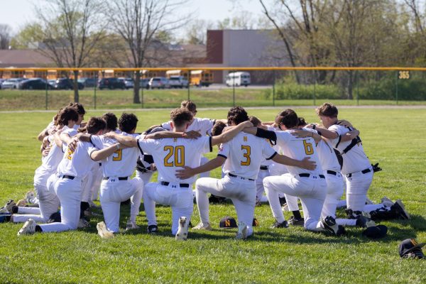 Varsity Baseball huddles up after a game against Liberty on April 8.