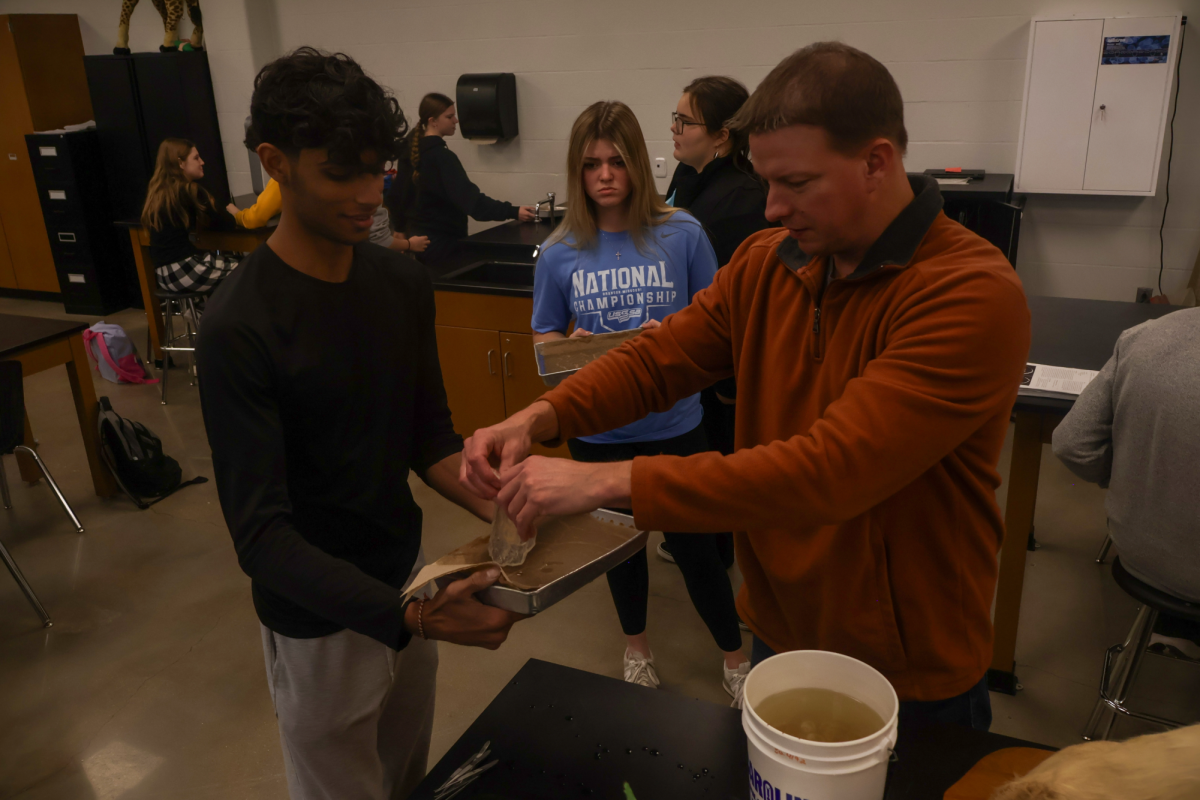 Science teacher Joe Brocksmith helps Avee Patel with dissection in Biology II.