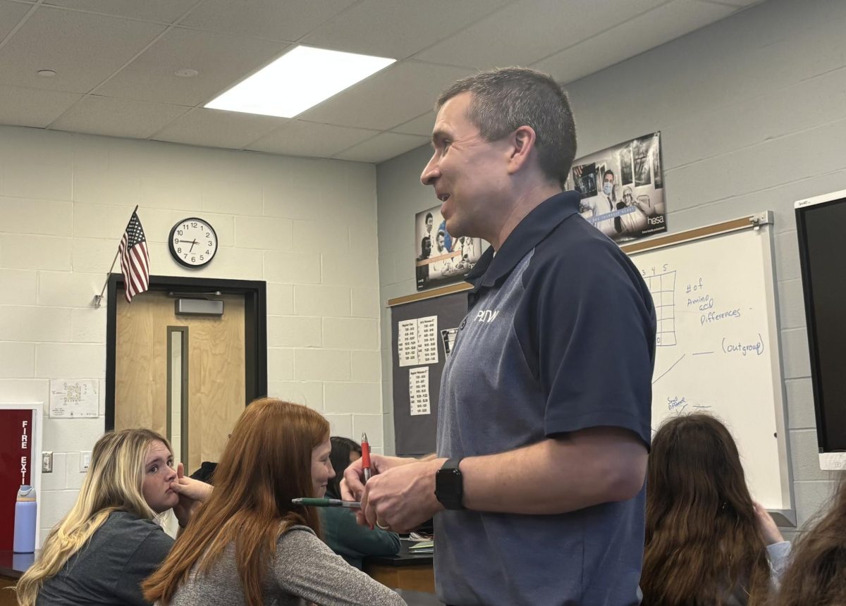 Science teacher Christopher Dalton converses with students in AP Biology. He is one of the many faculty that have served in the military, using his experiences to craft responsible and accountable students.