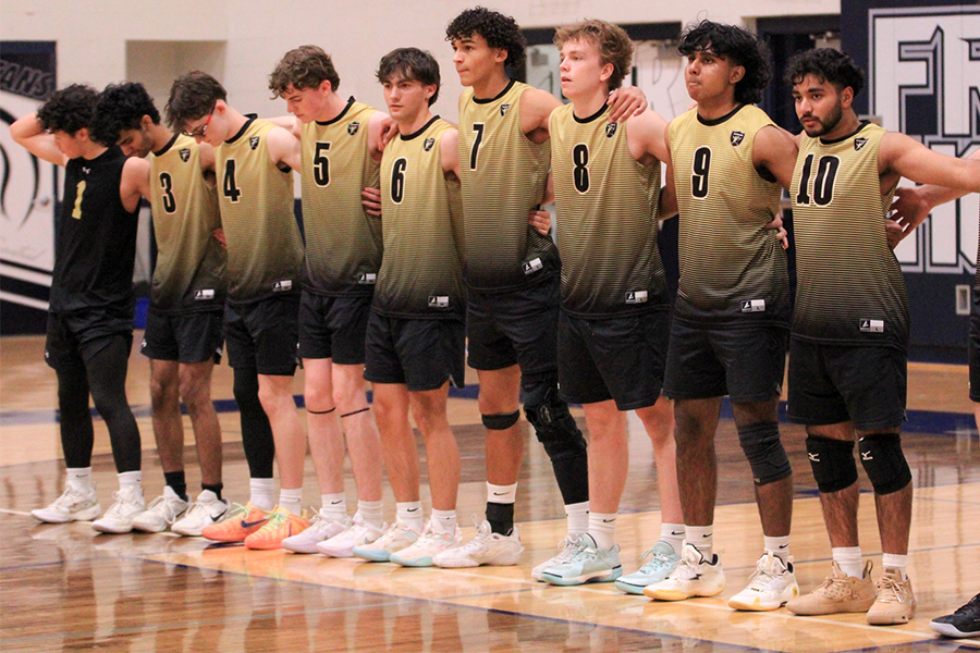 Boys volleyball team standing on the end line ready for their game against FHC